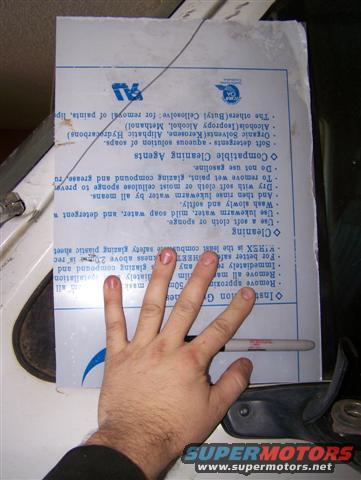 Document with cleaning instructions held by a hand with a marker