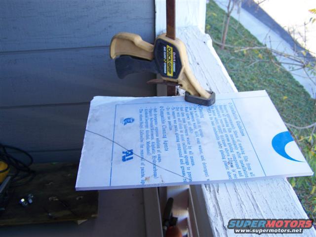 Document clamped to a white railing with instructions