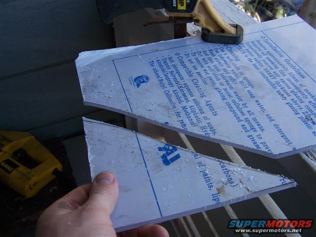 Hand holding cut plastic sheet with installation instructions; yellow Dewalt tool in background