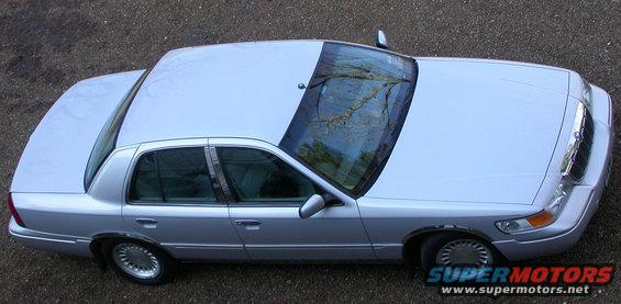 Silver sedan parked on gravel, viewed from above