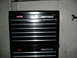 1997 Ford Crown Victoria - A black Craftsman tool chest is shown against a white wall with a horse silhouette on the right.