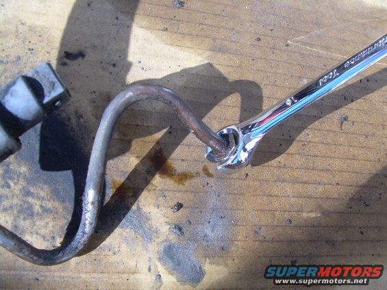 Metal tube being worked on by a wrench. Text on wrench reads 'Performance Tool 16'