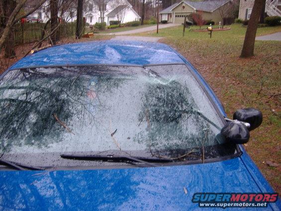 Blue 1998 Ford Crown Victoria with cracked windshield and two side mirrors visible