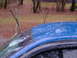 1998 Ford Crown Victoria - Close-up of a damaged blue car roof with water on its surface.