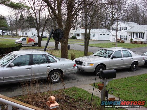 Silver 2003 Ford Crown Victoria parked on a residential street, front 3/4 view