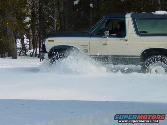 1986 Ford Bronco side view driving through snow