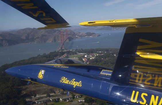 Blue Angels jet in flight with Golden Gate Bridge in background