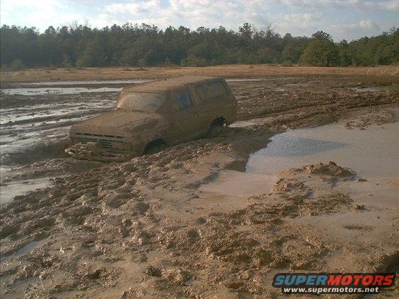1978 Ford Bronco stuck deep in mud, front grille submerged