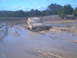 1978 Ford Bronco - This vehicle is deeply stuck in a muddy area, with only the top half visible above the muck.