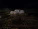 1978 Ford Bronco - A white SUV is stuck in the mud at night, with only its silhouette visible against the dark background.