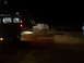 1978 Ford Bronco - A white SUV is stuck in a dirt embankment at night, with a tow truck nearby.