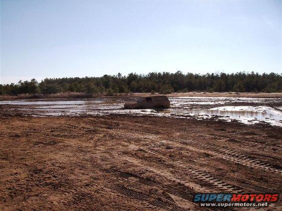 SUV stuck in mud, side view