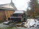 1990 Ford Bronco - An SUV body, missing its front end, is secured to a trailer for transport during a light snowfall.