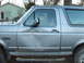 1995 Ford Bronco - Driver's side door of a 1995 Ford Bronco shows significant damage.