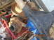 1991 Ford F-150 - Various rusty vehicle axle components are piled together, some in a red crate.