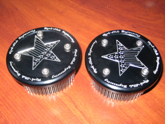 Two black circular parts with a star design and 'Rock-Slide Engineering' text