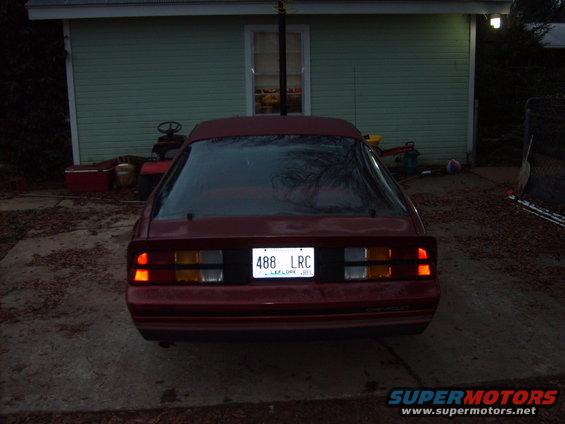 Red coupe's rear view. License plate reads 488 LRC. Appears to be from the 1980s