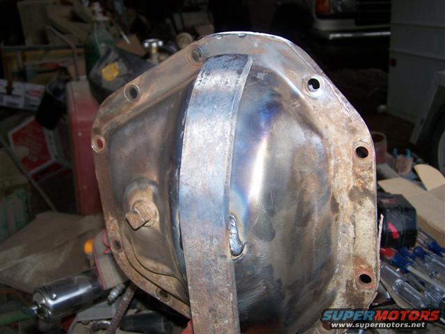 Differential cover with a welded reinforcement plate, showing discoloration from heat and rust