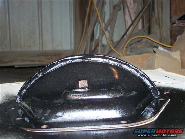 black metal automotive part with a bolt and gasket sealant