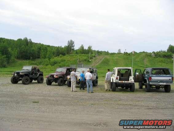 100_0014_2.jpg This the crew that went in...the rig on the far left is a 1 ton and glad it was...it pulled me up the trail when I had no rear driveshaft..just the open front...had to winch both of us strapped together with a snatch block to get us up...very cool