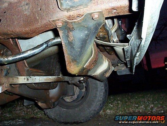 Undercarriage view of rusty truck frame and suspension components