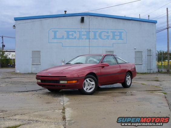 Red 1991 Ford Probe parked in front of a building with a Lehigh logo