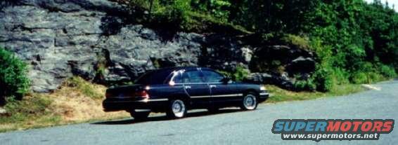 Dark 1997 Ford Crown Victoria sedan parked on a roadside