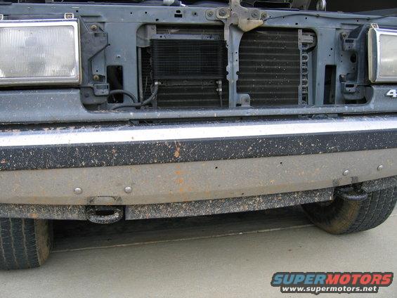 Truck front end with a tow hook and dirty bumper