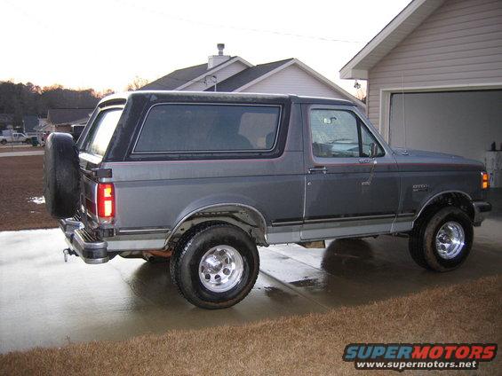 Gray 1989 Ford Bronco side view with spare tire on rear door
