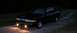 1997 Ford Crown Victoria - 1997 Ford Crown Victoria parked on gravel at night with headlights illuminated.