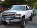 2001 Dodge 2500 - White 2001 Dodge 2500 pickup truck with a soft tonneau cover and lifted suspension.