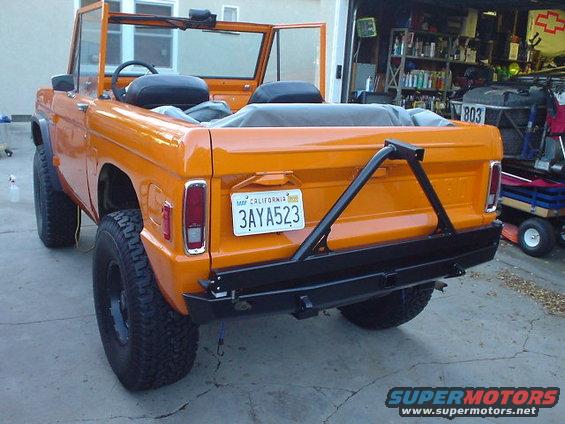 Orange 1977 Ford Bronco rear view with aftermarket bumper