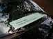 1997 Ford Crown Victoria - A sign is placed on the windshield of a black car, obscuring the view of the interior.