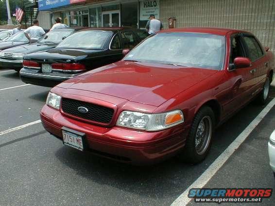 Red 1997 Ford Crown Victoria front view with license plate 7151 ME