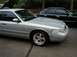 1997 Ford Crown Victoria - A silver sedan with aftermarket wheels is parked next to a black sedan.