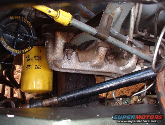 07strgshaft.jpg Looking down the L side of the engine showing the steering shaft that I had fabricated to join the '88 tilt/cruise column to the '75 power steering box.

The oil pressure sender wire is disconnected because the guy in BR managed to burn out that sender AND the temperature sender.

I plan to connect the brake pressure warning switch & the e-brake pedal switch eventually, but we have to decide where to put the warning light.