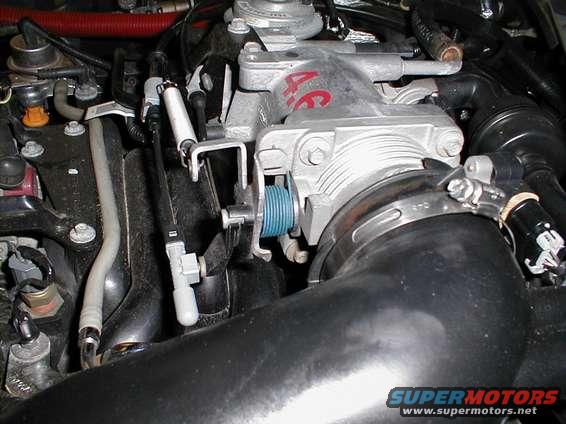 Engine intake manifold with '4.6' marking and blue throttle cable pulley