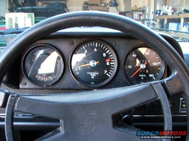 1974 Porsche 914 dashboard with tachometer, speedometer, and oil pressure gauge visible behind the steering wheel