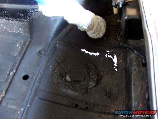 Interior floor pan with white paint splatters and a white tube
