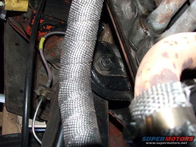Engine bay detail with exhaust pipe and heat wrap