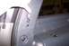 2002 Chevrolet Suburban - A hand operates a chrome latch on a gray interior trim panel.