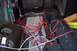 2002 Chevrolet Suburban - The interior of a vehicle is disassembled, revealing a complex network of exposed wiring and tangled wiring.