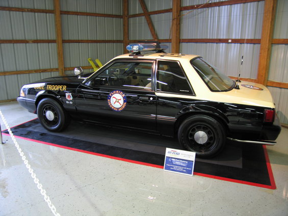 Side view of black and tan Florida Highway Patrol car with light bar