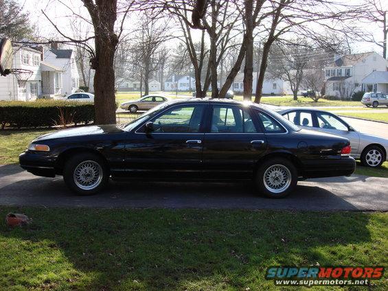 Black 2003 Ford Crown Victoria sedan, side view