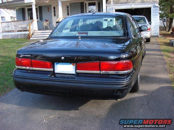 Black 1997 Ford Crown Victoria sedan, rear view, parked in driveway