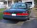 2003 Ford Crown Victoria - Rear view of a black 1997 Ford Crown Victoria sedan parked in a driveway with a house in the background.