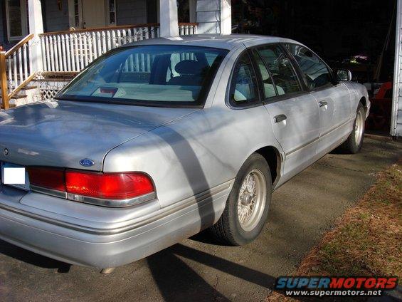 Silver 2003 Ford Crown Victoria, rear quarter view, parked in driveway