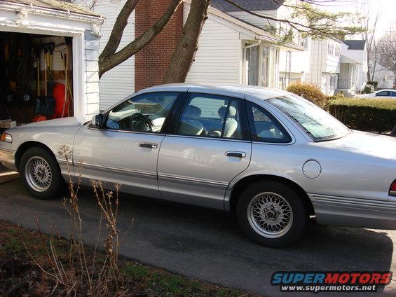 Silver 2003 Ford Crown Victoria sedan, side view
