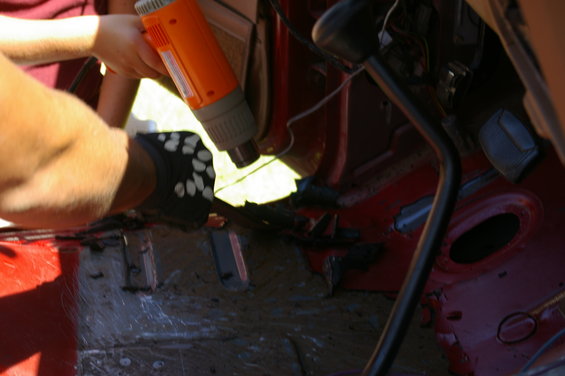 Interior of vehicle with heat gun being used on floor