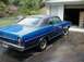 1968 Ford Torino - This 1968 Ford Torino coupe features a blue exterior with a contrasting black vinyl top and is shown from the rear three-quarter angle.